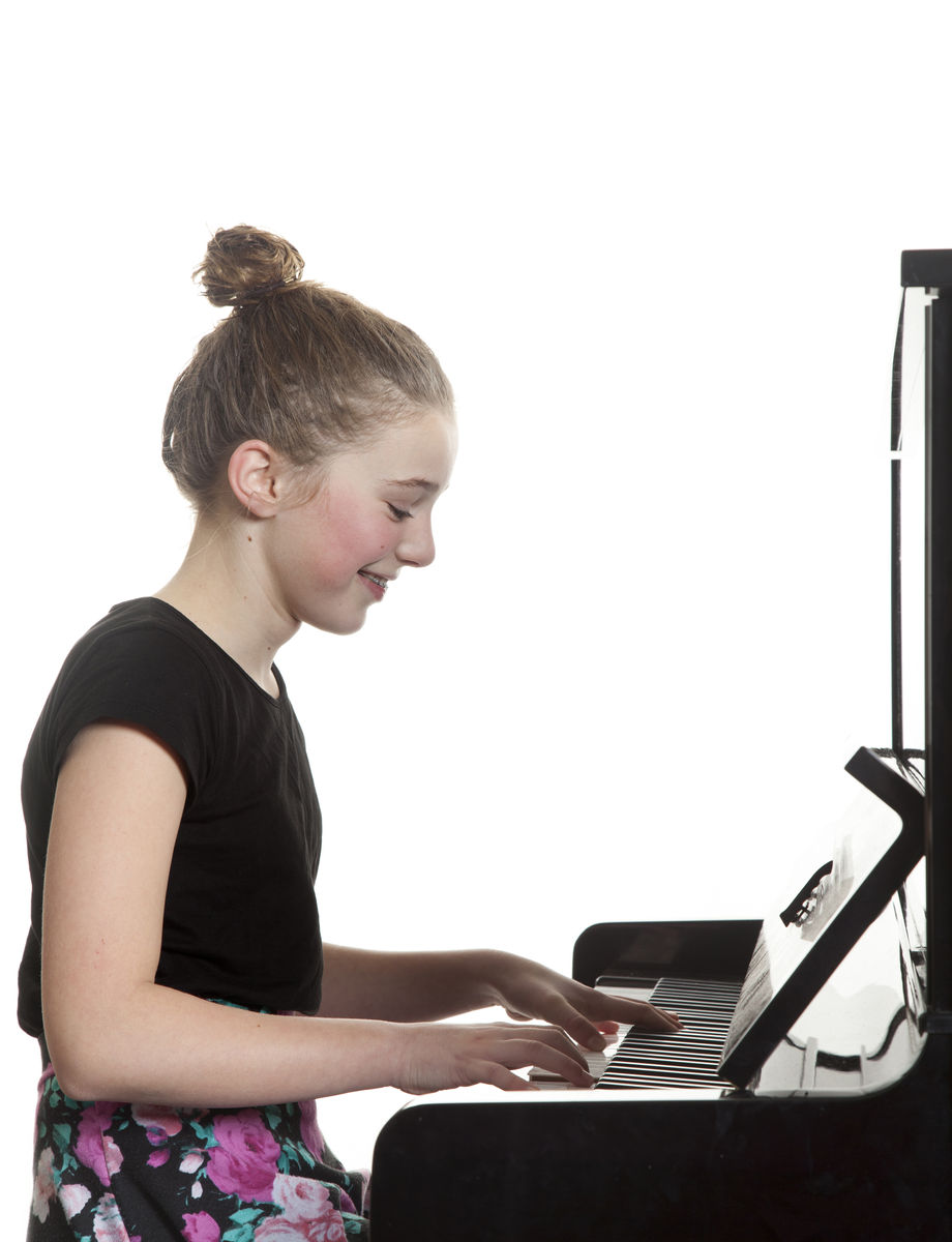 A young pianist playing a grand piano